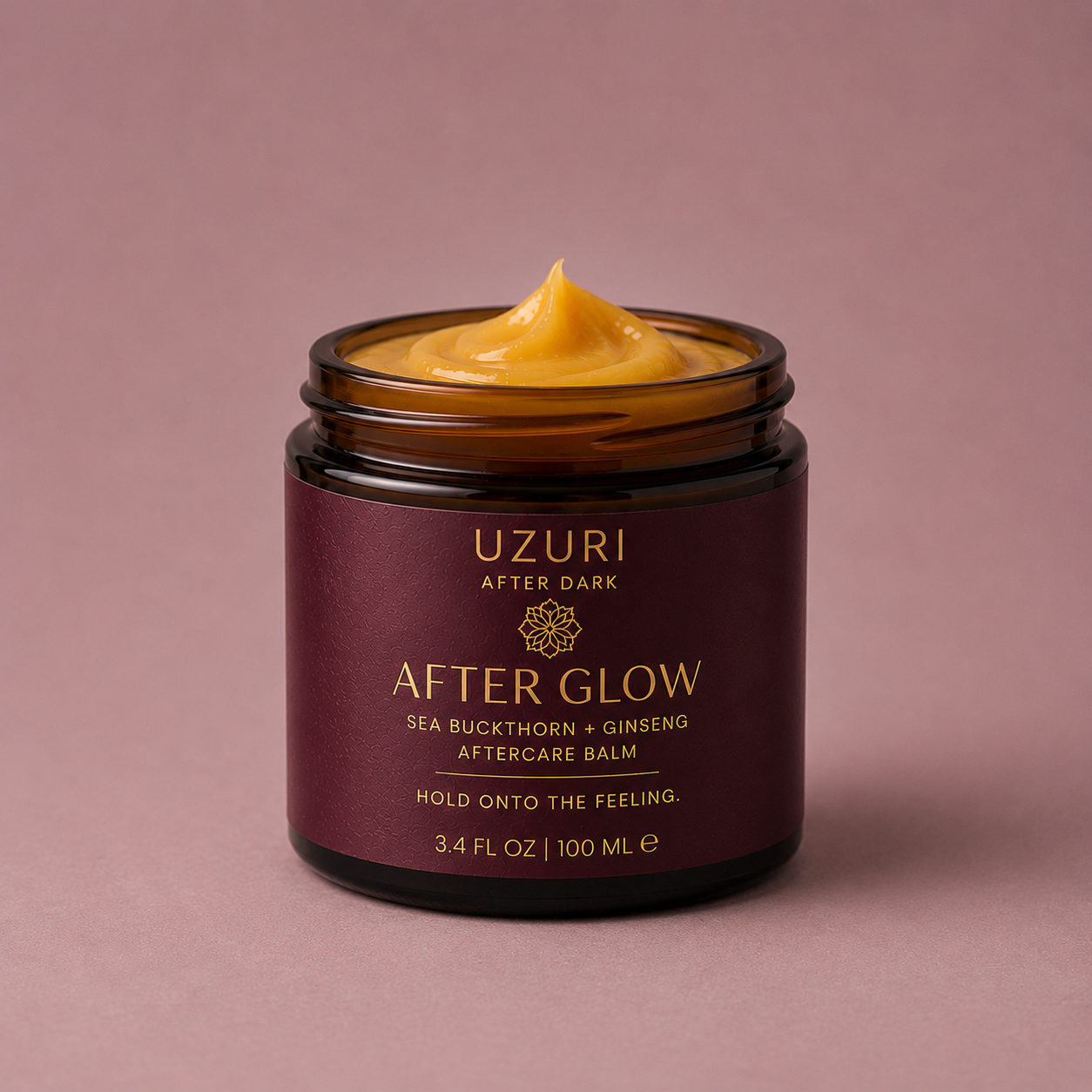 Jar of Uzuri After Glow balm on a pink background